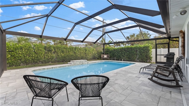 view of swimming pool with a patio area and a lanai