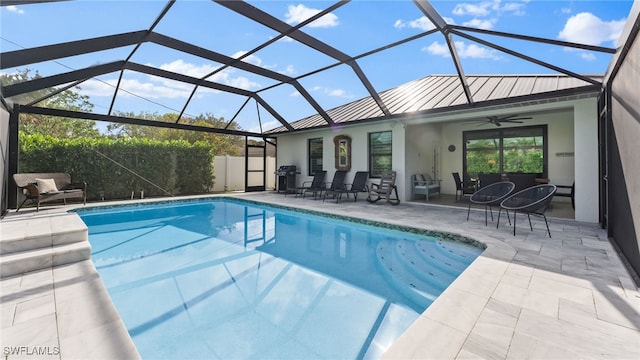 view of swimming pool featuring a lanai, ceiling fan, and a patio