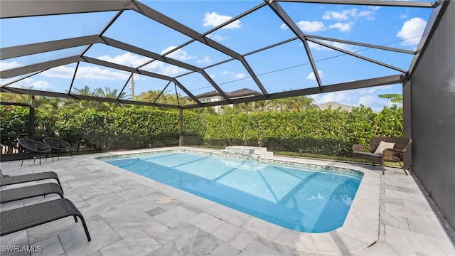 view of pool featuring glass enclosure and a patio area