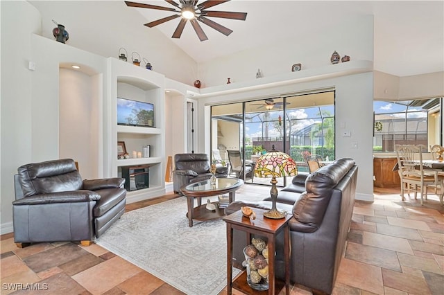 living room with high vaulted ceiling, built in features, and ceiling fan