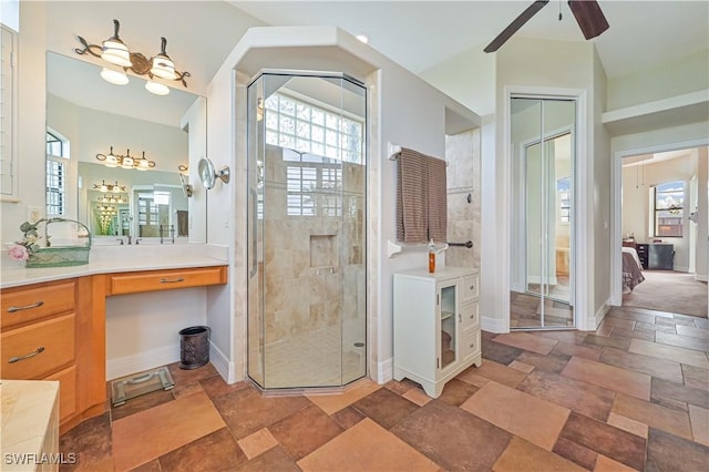 bathroom with ceiling fan, an enclosed shower, and vanity