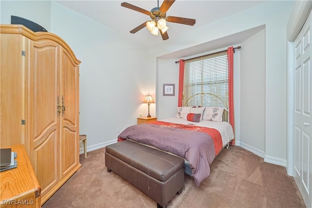 bedroom with ceiling fan, a closet, and light carpet