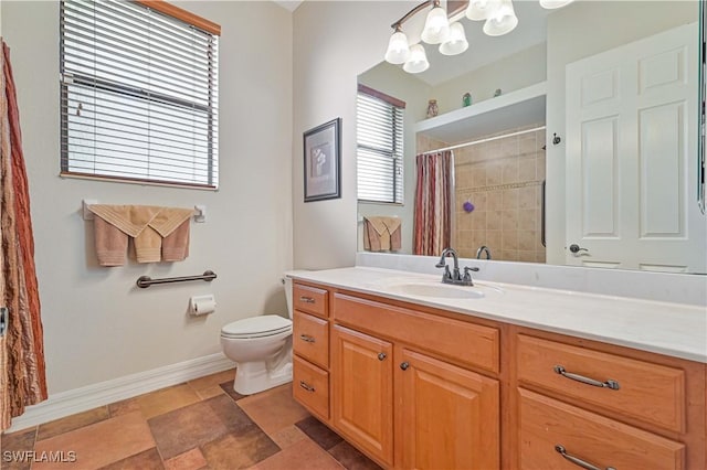 bathroom with curtained shower, vanity, and toilet