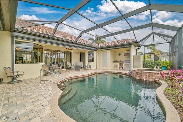 view of swimming pool with a patio area, ceiling fan, an in ground hot tub, and glass enclosure