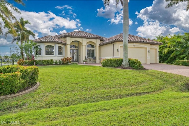 mediterranean / spanish-style house featuring a garage and a front yard