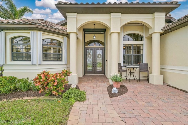 view of exterior entry featuring french doors