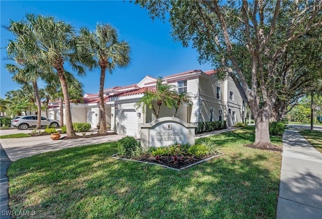 view of front facade with a garage and a front lawn