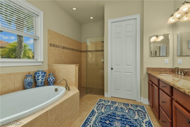 bathroom featuring tile patterned flooring, vanity, and independent shower and bath