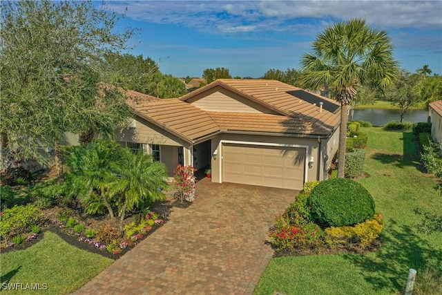 ranch-style house with a water view, a front yard, and a garage