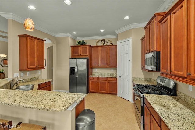 kitchen with sink, hanging light fixtures, crown molding, a breakfast bar, and appliances with stainless steel finishes