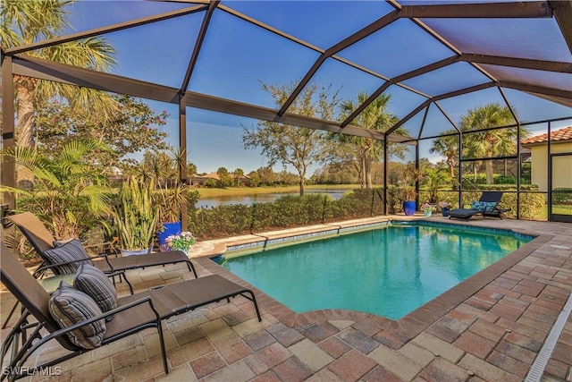 view of swimming pool featuring a lanai, a patio area, and a water view