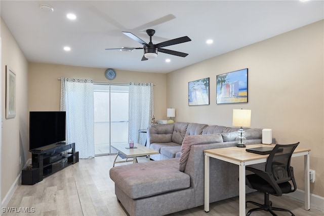 living room featuring ceiling fan and light hardwood / wood-style floors