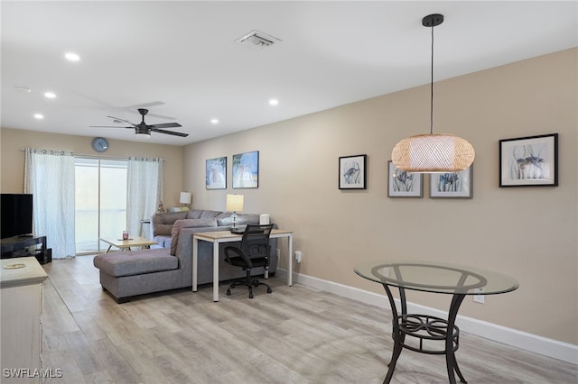 home office with ceiling fan and light hardwood / wood-style flooring