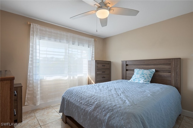 bedroom with light tile patterned floors and ceiling fan