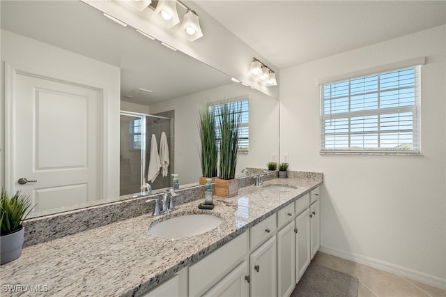 bathroom with tile patterned flooring, vanity, and an enclosed shower