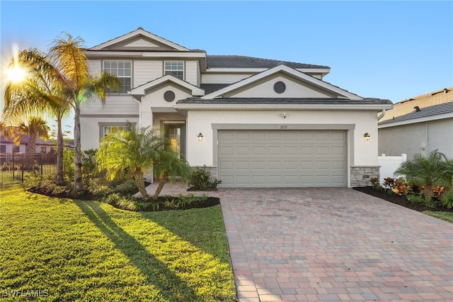 view of front of home with a garage and a front lawn