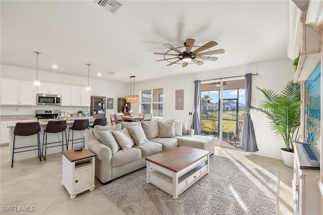 tiled living room featuring ceiling fan