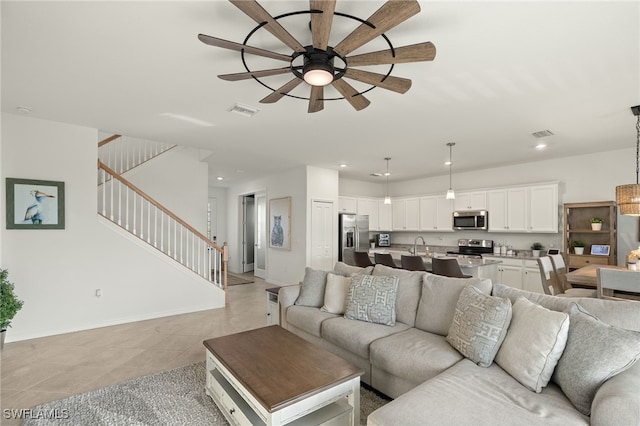 tiled living room featuring ceiling fan