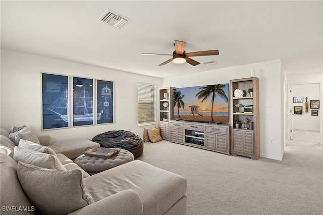 living room with ceiling fan and carpet