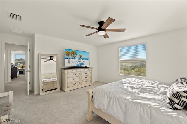 carpeted bedroom featuring ceiling fan and multiple windows