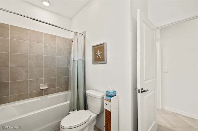 bathroom featuring tile patterned floors, shower / bath combination with curtain, and toilet