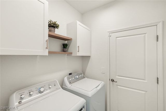 laundry area featuring cabinets and separate washer and dryer