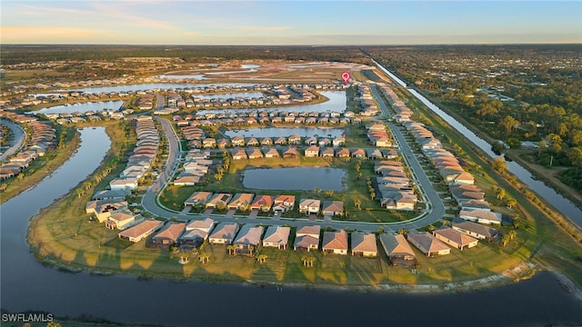 aerial view at dusk with a water view