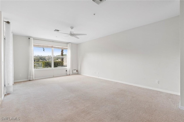 spare room with light carpet and ceiling fan