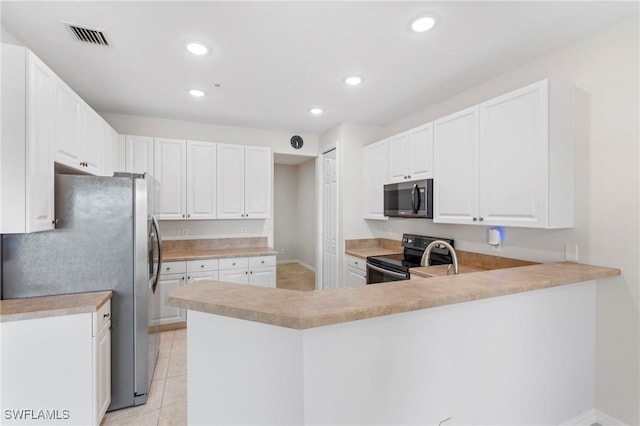 kitchen featuring kitchen peninsula, white cabinets, light tile patterned floors, and appliances with stainless steel finishes