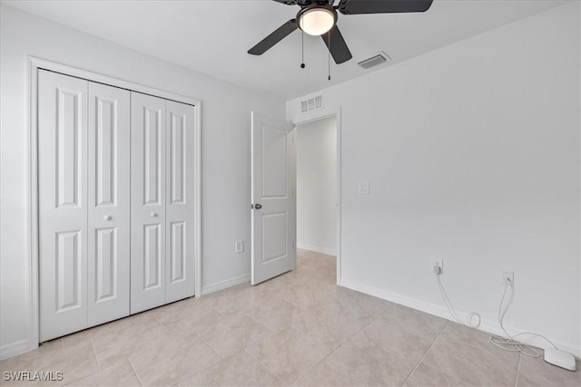 unfurnished bedroom featuring light tile patterned floors, a closet, and ceiling fan