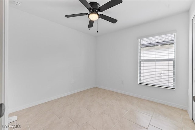 tiled empty room featuring ceiling fan