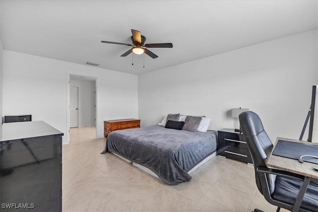 tiled bedroom featuring ceiling fan