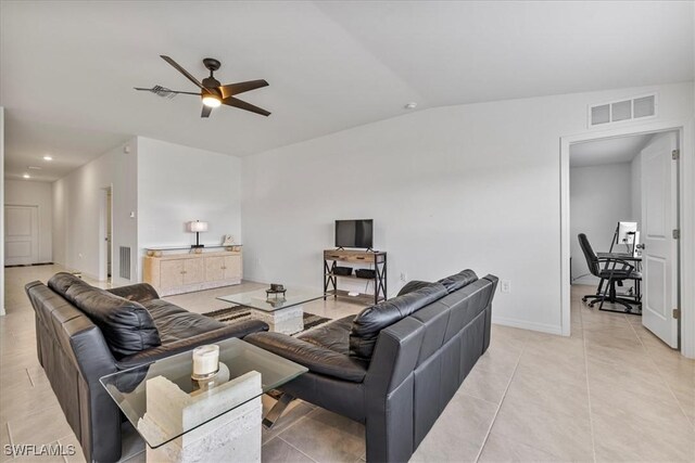 tiled living room with ceiling fan and lofted ceiling