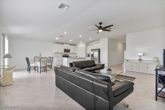 living room with ceiling fan and light tile patterned floors