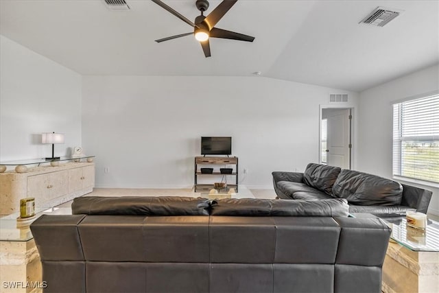 living room featuring ceiling fan and vaulted ceiling