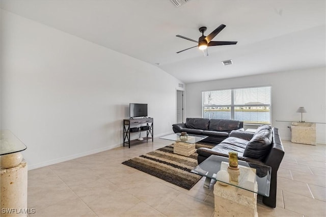 living room featuring ceiling fan, lofted ceiling, and light tile patterned floors