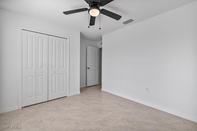 unfurnished bedroom featuring a closet and ceiling fan