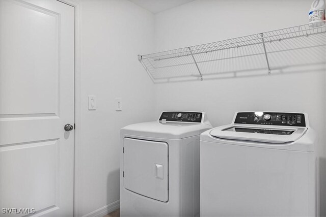 clothes washing area featuring washing machine and dryer