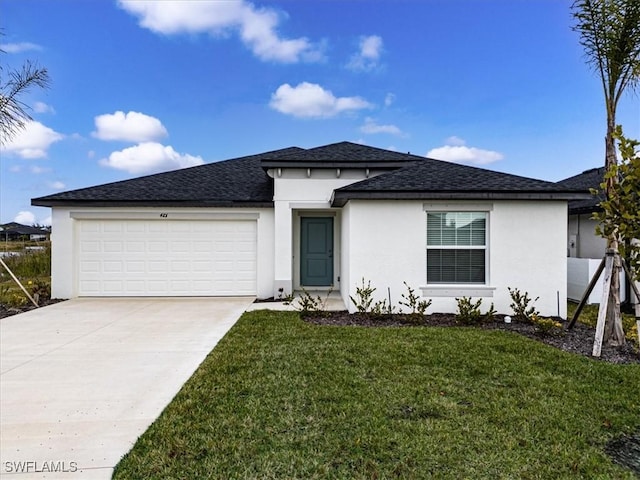 view of front of home with a front yard and a garage