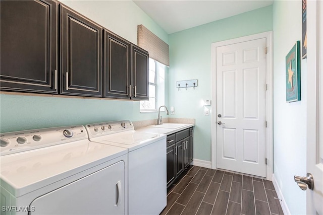 laundry area featuring cabinets, sink, and washing machine and clothes dryer