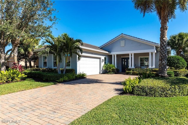 view of front of home featuring a front yard and a garage