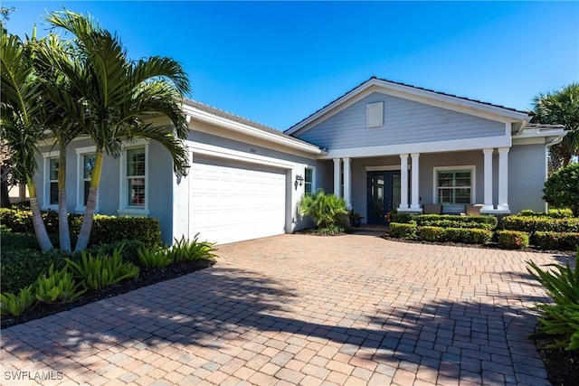 view of front of house featuring covered porch and a garage