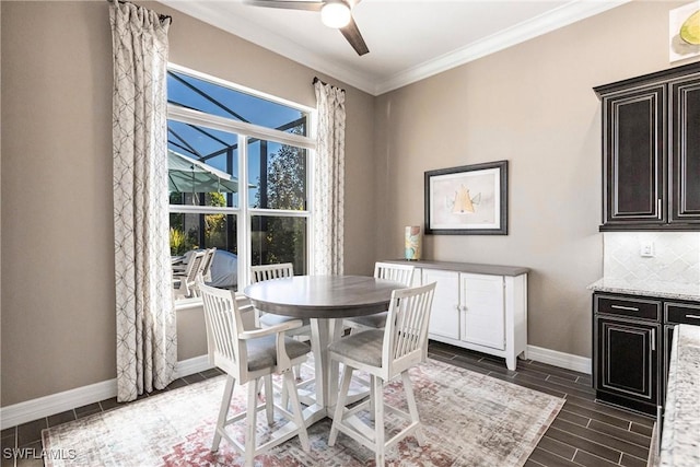 dining space with ceiling fan and crown molding