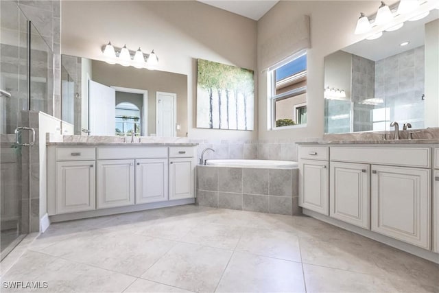 bathroom with tile patterned floors, vanity, and plus walk in shower