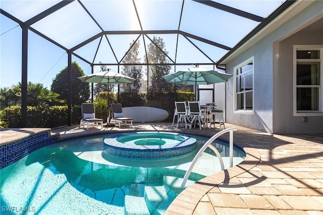 view of pool featuring a lanai, an in ground hot tub, and a patio