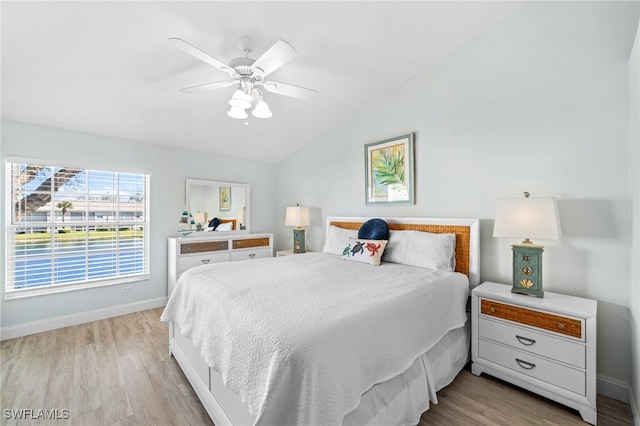 bedroom featuring ceiling fan, lofted ceiling, and light hardwood / wood-style flooring