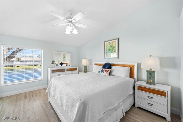 13120 Castle Harbour Dr Unit N4, Naples, FL 34110 - bedroom featuring wood finished floors, vaulted ceiling, baseboards, and ceiling fan
