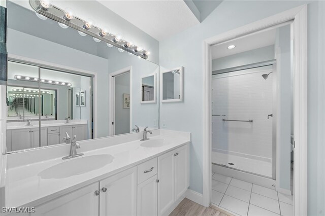 13120 Castle Harbour Dr Unit N4, Naples, FL 34110 - full bath featuring double vanity, a shower stall, baseboards, and tile patterned flooring