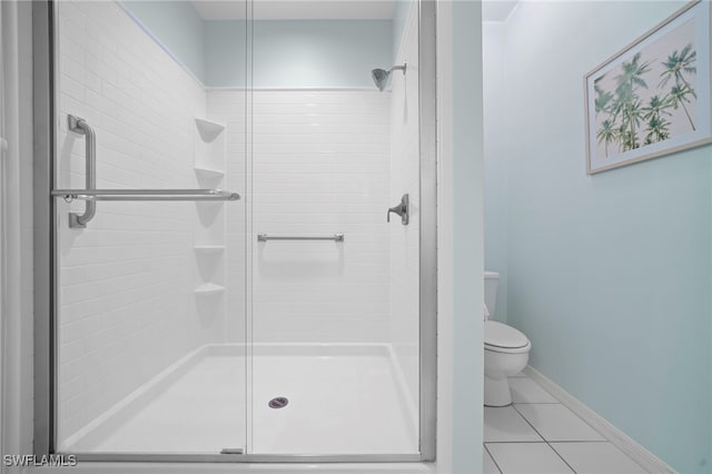 bathroom with tile patterned flooring, an enclosed shower, and toilet