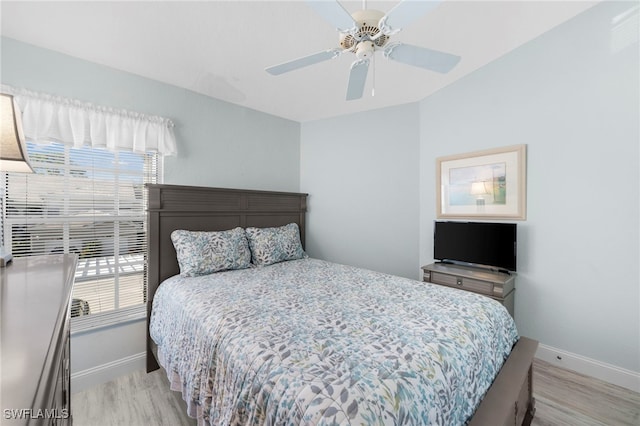 bedroom with multiple windows, light wood-type flooring, and ceiling fan